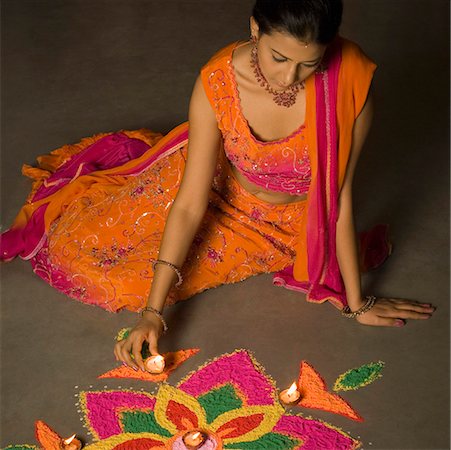 High angle view of a young woman making a rangoli Stock Photo - Premium Royalty-Free, Code: 630-01877278