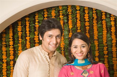 diwali couple pic - Portrait of a couple standing together and smiling Stock Photo - Premium Royalty-Free, Code: 630-01877398