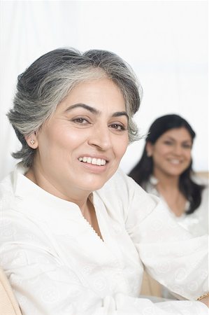 simsearch:630-01877517,k - Close-up of a mature woman smiling with her daughter in the background Stock Photo - Premium Royalty-Free, Code: 630-01877516