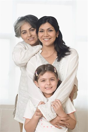 Portrait of a mature woman with her daughter and granddaughter smiling Stock Photo - Premium Royalty-Free, Code: 630-01877525