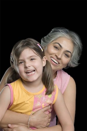 Portrait of a mature woman smiling with her granddaughter Stock Photo - Premium Royalty-Free, Code: 630-01877529