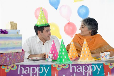 Mid adult man with his mother celebrating his birthday Stock Photo - Premium Royalty-Free, Code: 630-01877552