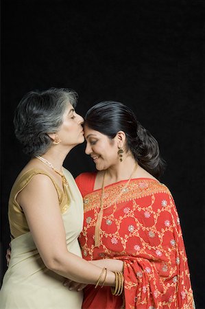 saree indian moms - Side profile of a mature woman kissing on forehead of her daughter Stock Photo - Premium Royalty-Free, Code: 630-01877600