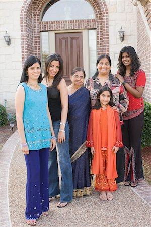 smile desi girl images - Portrait of a family standing together Stock Photo - Premium Royalty-Free, Code: 630-01877786