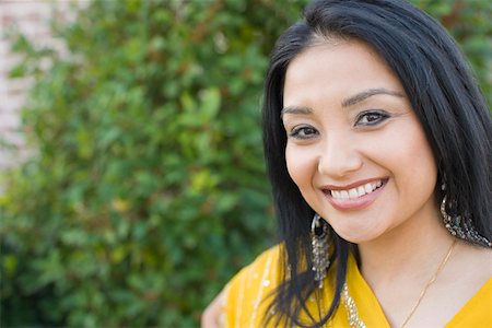 desi adults - Portrait of a young woman smiling Stock Photo - Premium Royalty-Free, Code: 630-01877792