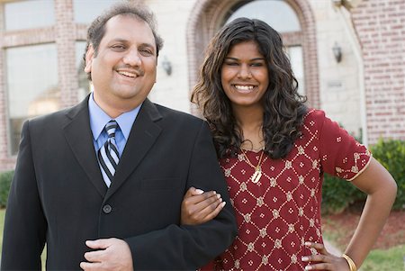 father arms - Portrait of a mature man and his daughter smiling with their arm in arm Stock Photo - Premium Royalty-Free, Code: 630-01877806