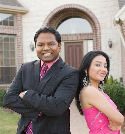 desi adults - Portrait of a mid adult man and a young woman standing Stock Photo - Premium Royalty-Free, Code: 630-01877817