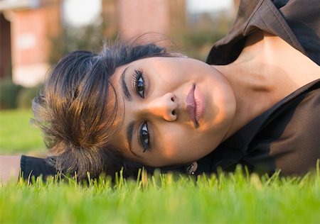 desi adults - Portrait of a young woman lying on the grass and thinking Stock Photo - Premium Royalty-Free, Code: 630-01877826