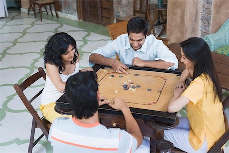 simsearch:630-01491245,k - High angle view of two young men and two young women playing carom Stock Photo - Premium Royalty-Free, Code: 630-01872292