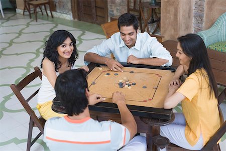 simsearch:630-01491245,k - Four people playing carom Stock Photo - Premium Royalty-Free, Code: 630-01872293