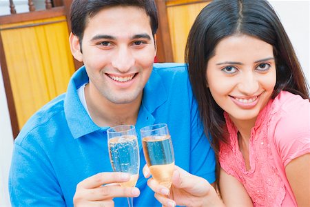 draperies glass - Portrait of a young couple toasting with champagne flutes Stock Photo - Premium Royalty-Free, Code: 630-01872609