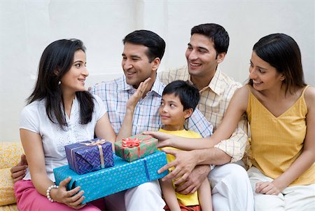 simsearch:640-01364378,k - Mid adult woman holding gifts and sitting with her family Stock Photo - Premium Royalty-Free, Code: 630-01872714