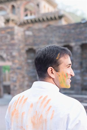 simsearch:630-01873035,k - Close-up of a mid adult man with powder paint on his face and smiling Stock Photo - Premium Royalty-Free, Code: 630-01873033