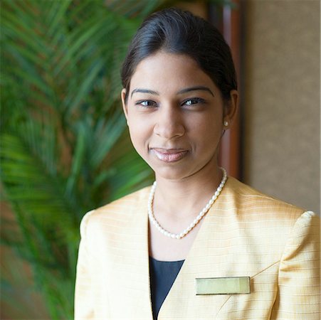 female hostess - Portrait of a waitress smirking Stock Photo - Premium Royalty-Free, Code: 630-01873050