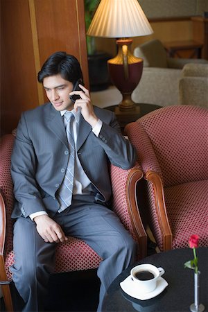 flower lobby - Businessman talking on a mobile phone Stock Photo - Premium Royalty-Free, Code: 630-01873073