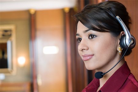 female agent - Close-up of a female customer service representative wearing a headset and smiling Stock Photo - Premium Royalty-Free, Code: 630-01873152