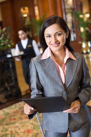 Portrait of a businesswoman holding a file and smiling Stock Photo - Premium Royalty-Free, Code: 630-01873245