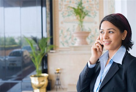 simsearch:630-01873262,k - Close-up of a businesswoman talking on a mobile phone and smiling Stock Photo - Premium Royalty-Free, Code: 630-01873255