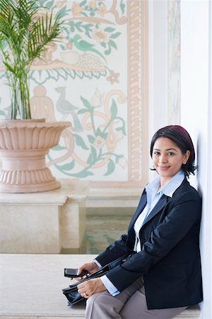 Portrait of a businesswoman smiling Stock Photo - Premium Royalty-Free, Code: 630-01873260