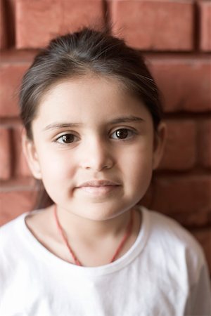 Portrait of a girl in front of a wall Stock Photo - Premium Royalty-Free, Code: 630-01873418