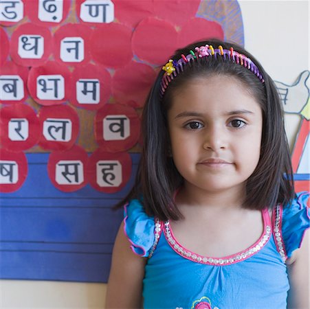 Portrait of a schoolgirl standing in front of a chart Stock Photo - Premium Royalty-Free, Code: 630-01873440