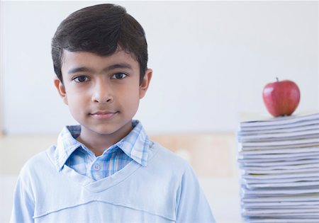 simsearch:630-01492101,k - Portrait of a schoolboy with an apple on a stack of books behind him Stock Photo - Premium Royalty-Free, Code: 630-01873452