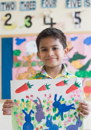 elementary drawing pictures - Close-up of a schoolboy showing a painting Stock Photo - Premium Royalty-Free, Code: 630-01873478