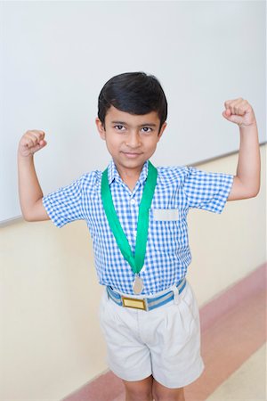 school awards - School boy with a medal around his neck and flexing muscles Stock Photo - Premium Royalty-Free, Code: 630-01873522