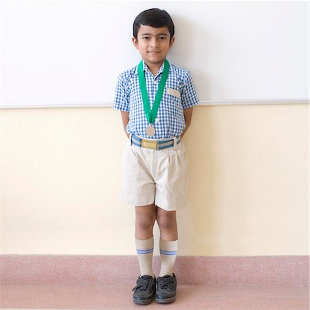 simsearch:630-01873811,k - Portrait of a schoolboy standing in a classroom and leaning against a wall Foto de stock - Sin royalties Premium, Código: 630-01873523