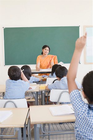 studying young asian boy - Mid adult woman teaching students in a classroom Stock Photo - Premium Royalty-Free, Code: 630-01873568