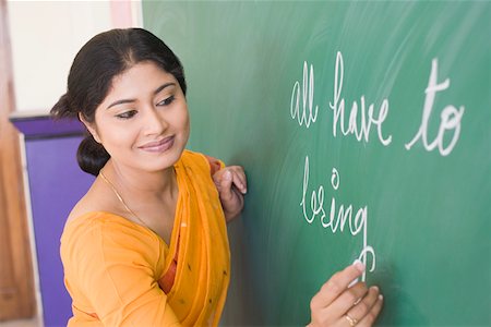 School teacher teaching in a classroom Foto de stock - Sin royalties Premium, Código: 630-01873593