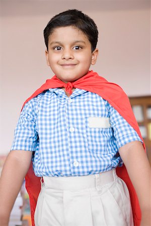 simsearch:630-01873486,k - Portrait of a boy imitating to be a superhero and smiling Foto de stock - Royalty Free Premium, Número: 630-01873625