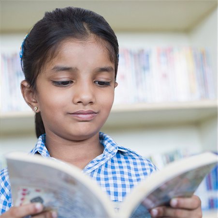 elementary school girl indian - Close-up of a schoolgirl reading a book Stock Photo - Premium Royalty-Free, Code: 630-01873627