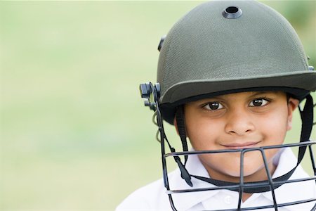 Portrait of a boy wearing sports helmet and smiling Stock Photo - Premium Royalty-Free, Code: 630-01873679