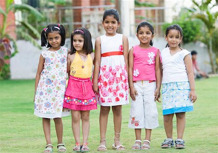 simsearch:625-01752943,k - Five girls standing in a lawn and smiling Stock Photo - Premium Royalty-Free, Code: 630-01873684