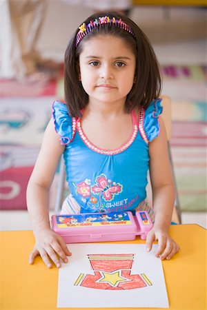 Portrait of a girl with her drawing in the classroom Stock Photo - Premium Royalty-Free, Code: 630-01873726