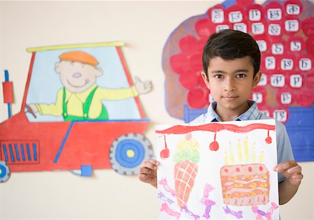 elementary drawing pictures - Portrait of a schoolboy holding a drawing and smiling Stock Photo - Premium Royalty-Free, Code: 630-01873745