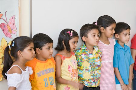 simsearch:625-01752943,k - Group of students standing in a row in the classroom Stock Photo - Premium Royalty-Free, Code: 630-01873747