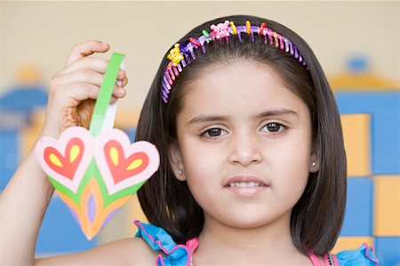 Portrait of a girl holding a paper craft product Stock Photo - Premium Royalty-Free, Code: 630-01873749