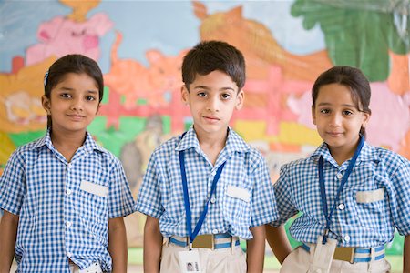 elementary student uniform - Portrait of three schoolchildren standing in a row Stock Photo - Premium Royalty-Free, Code: 630-01873775