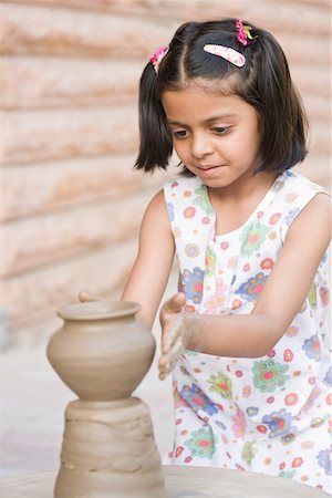 Close-up of a girl making a pottery Stock Photo - Premium Royalty-Free, Code: 630-01873837