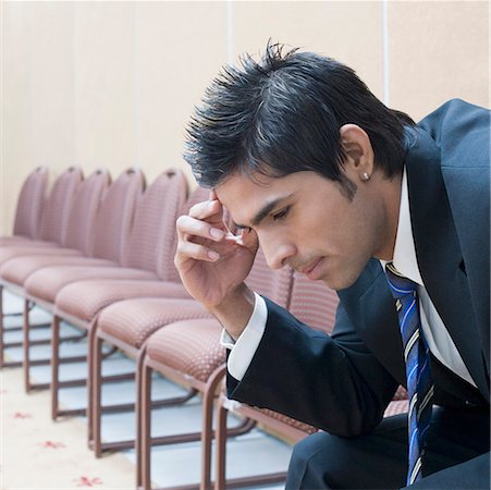 Side profile of a businessman suffering from a headache Stock Photo - Premium Royalty-Free, Code: 630-01873884