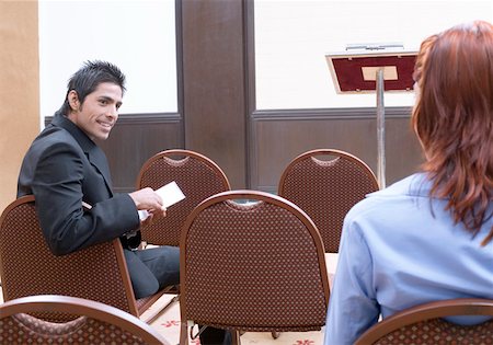 Rear view of a businesswoman with a businessman sitting in a conference room Stock Photo - Premium Royalty-Free, Code: 630-01873892
