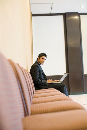 Side profile of a businessman using a laptop Stock Photo - Premium Royalty-Free, Code: 630-01873919