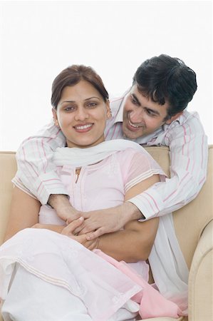 simsearch:630-02219591,k - Mid adult man arm around a mid adult woman from behind and smiling Stock Photo - Premium Royalty-Free, Code: 630-02219220