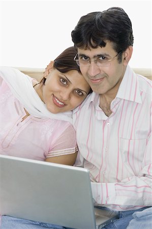 simsearch:630-02219591,k - Portrait of a mid adult couple using a laptop and smiling Stock Photo - Premium Royalty-Free, Code: 630-02219221