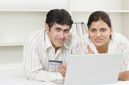 simsearch:630-02219591,k - Portrait of a mid adult couple shopping online with a credit card and smiling Stock Photo - Premium Royalty-Free, Code: 630-02219222