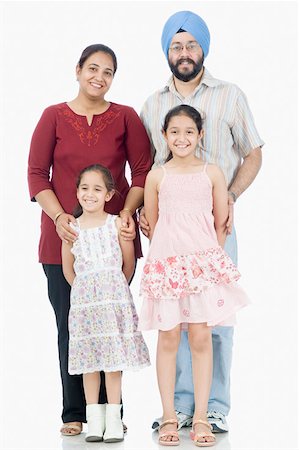 simsearch:630-02219463,k - Portrait of a mid adult couple with their two daughters standing together Foto de stock - Sin royalties Premium, Código: 630-02219261