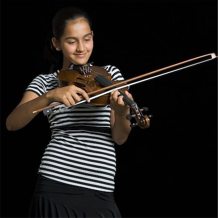 Close-up of a teenage girl playing a violin Stock Photo - Premium Royalty-Free, Code: 630-02219278