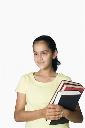 Teenage girl holding books Stock Photo - Premium Royalty-Free, Code: 630-02219282